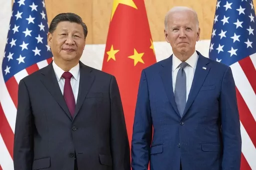 U.S. President Joe Biden, right, stands with Chinese President Xi Jinping before a meeting on the sidelines of the G20 summit on Nov. 14, 2022, in Bali, Indonesia. When Washington and Beijing do economic battle – as they have for five years now – the rest of the world suffers, too. And when they hold a top-level summit – as Biden and Xi will this week – the rest of the world pays attention. (AP Photo/Alex Brandon, File)