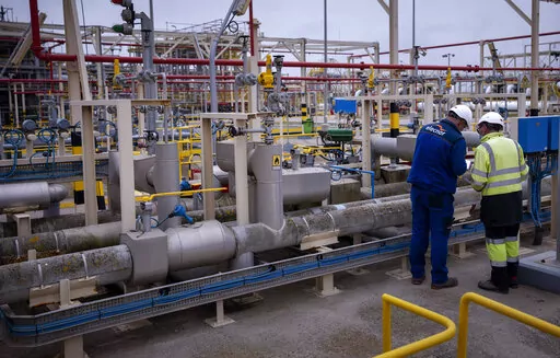 Operators work at Enagas regasification plant, the largest LNG plant in Europe, in Barcelona, Spain, March 29, 2022. Natural gas and electricity prices in Europe have plunged from summer peaks thanks to mild weather and a monthslong scramble to fill gas storage ahead of winter and replace Russian supplies during the war in Ukraine. It's a welcome respite after Russia slashed natural gas flows, triggering an energy crisis that has fueled record inflation and a looming recession. (AP Photo/Emilio 