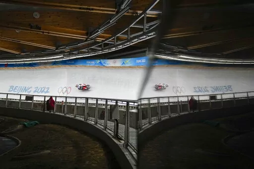 Makena Hodgson, of Canada, slides during the luge women's singles run 1 at the 2022 Winter Olympics, Monday, Feb. 7, 2022, in the Yanqing district of Beijing. (AP Photo/Pavel Golovkin)