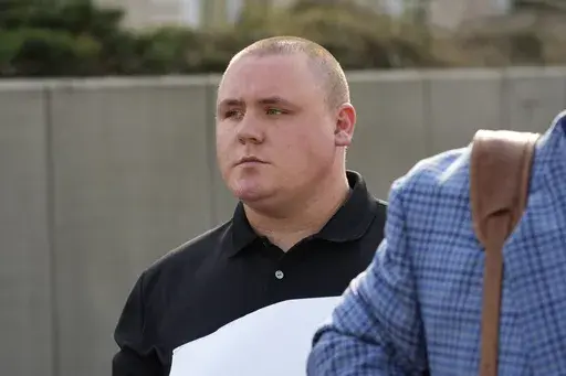 Former City of Pearl, Miss., police Officer Michael Christian Green walks out of the federal courthouse in Jackson, Miss., March 14, 2024, after pleading guilty to a federal misdemeanor charge after authorities said he forced a man he had arrested to lick urine off the floor of a jail cell. Green was sentenced Wednesday, June 12, to one year in federal prison, the maximum penalty for the charge. (AP Photo/Rogelio V. Solis, File)