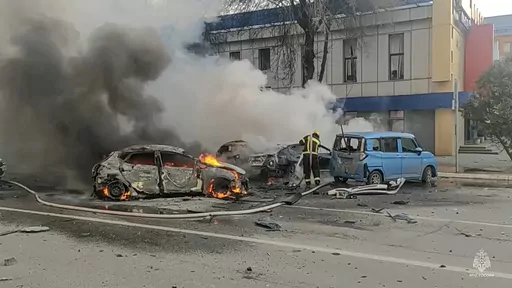 In this photo taken from video released by Russia Emergency Situations Ministry telegram channel on Saturday, Dec. 30, 2023, firefighters extinguish burning cars after shelling in Belgorod, Russia. Russian officials have accused Ukrainian forces of shelling the Russian border city of Belgorod. Two children were killed in Saturday's attack, regional governor Vyacheslav Gladkov said in a statement on social media. He also said that an unspecified number of people had been injured. (Russia Emergenc
