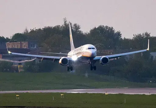 A Ryanair plane with registration number SP-RSM, that was carrying Belarus opposition journalist Raman Pratasevich from Athens to Vilnius and was diverted to Minsk, Belarus, after a bomb threat, lands at the International Airport outside Vilnius, Lithuania, on May 23, 2021.. U.S. prosecutors charged four Belarusian government officials on Thursday, Jan. 20, 2022, with aircraft piracy for diverting a Ryanair flight last year to arrest an opposition journalist, using a ruse that there was a bomb t