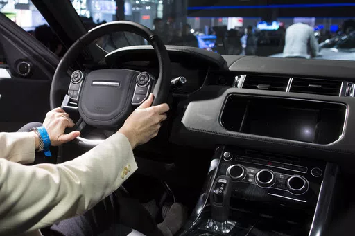 The 2014 Range Rover Sport is unveiled during the 2013 New York International Auto Show at the Jacob K. Javits Convention Center, March 27, 2013, in New York. Federal auto safety regulators are warning people not to stick decals on their steering wheels because they can be hurled at drivers if the air bags inflate in a crash. (AP Photo/John Minchillo, File)