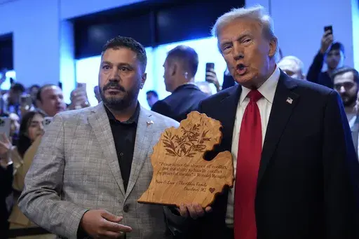 Republican presidential nominee former President Donald Trump talks with owner Albert Abbas as he visits The Great Commoner, Friday, Nov. 1, 2024, in Dearborn, Mich. (AP Photo/Julia Demaree Nikhinson)