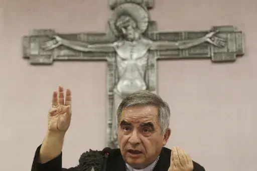 Cardinal Angelo Becciu talks to journalists during a news conference in Rome, Sept. 25, 2020. (AP Photo/Gregorio Borgia, File)