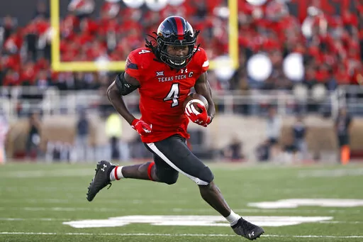 FILE -Texas Tech's SaRodorick Thompson (4) runs to score a touchdown during the second half of an NCAA college football game against Texas Tech, Saturday, Nov. 13, 2021, in Lubbock, Texas. Ole Miss looks to end a disappointing season on a positive note Wednesday night, Dec. 28, 2022 when the Rebels meet Texas Tech in the Texas Bowl. Texas Tech has a talented running back duo in SaRodorick Thompson and Tahj Brooks. Thompson leads Texas Tech with 670 yards rushing. (AP Photo/Brad Tollefson, File)