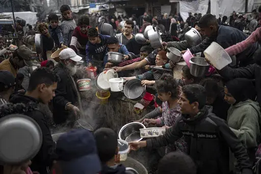 Palestinians line up for a meal in Rafah, Gaza Strip, Thursday, Dec. 21, 2023. The United Nations appealed for $2.8 billion on Tuesday, April 17, 2024, to provide desperately needed aid to 3 million Palestinians, stressing that tackling looming famine in war-torn Gaza requires not only food but sanitation, water and health facilities. (AP Photo/Fatima Shbair, File)
