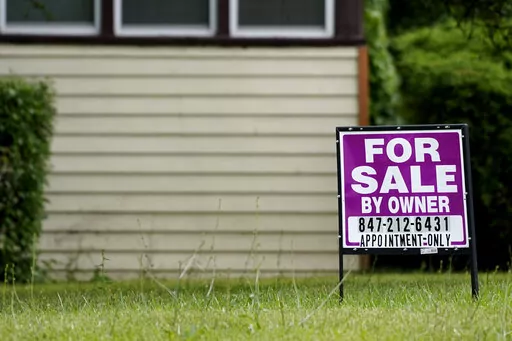 A sign is displayed in front of a home for sale in Prospect Heights, Ill., Thursday, July 10, 2022. Home sale cancellations hit highest rate since start of pandemic by Redfin.  Mortgage buyer Freddie Mac reports on key 30-year mortgage rates on Thursday, Nov. 17. (AP Photo/Nam Y. Huh)