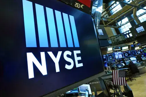 Logos the New York Stock Exchange adorn trading posts, on the floor, Wednesday, March 16, 2022. Stocks are opening lower on Wall Street Thursday but are still holding on to sizable gains for the week. Traders are turning cautious as oil prices surge again, pushing U.S. benchmark crude up 7% and back above $100 a barrel. (AP Photo/Richard Drew)