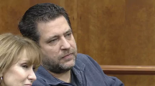 REMOVES SECOND REFERENCE TO TOWN DROPPING CHARGES FILE - This image taken from video provided by WTVG shows Pastor of Dad's Place Chris Avell, right, sitting inside Bryan Municipal Court on Thursday, Jan. 11, 2024, in Bryan, Ohio. (WTVG via AP)