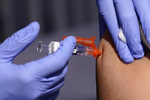 A patient is given a flu vaccine Friday, Oct. 28, 2022, in Lynwood, Calif. Seasonal flu continues to pick up steam in the U.S. But among respiratory viruses, COVID-19 remains the main cause of hospitalizations and deaths, health officials said Friday, Dec. 1, 2023. (AP Photo/Mark J. Terrill, File)