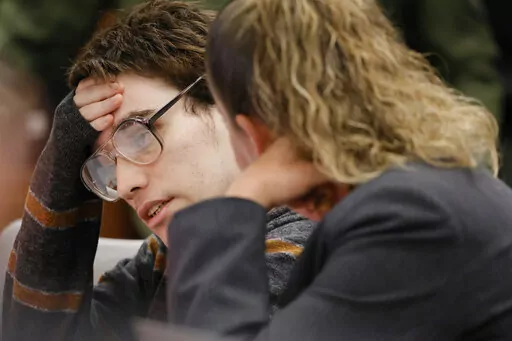 Marjory Stoneman Douglas High School shooter Nikolas Cruz, left, speaks with assistant public defender Nawal Bashimam during jury pre-selection in the penalty phase of his trial at the Broward County Courthouse in Fort Lauderdale, Fla., Tuesday, April 26, 2022. Cruz is facing a possible death sentence for murdering 17 at Marjory Stoneman Douglas High School in Parkland four years earlier. (Amy Beth Bennett/South Florida Sun-Sentinel via AP, Pool)