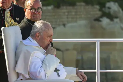 Pope Francis sits next to Malta's Archbishop Charles Jude Scicluna, left, aboard a catamaran leaving Valletta's harbor for Gozo in Malta Saturday, April 2, 2022. Pope Francis headed to the Mediterranean island nation of Malta on Saturday for a pandemic-delayed weekend visit, aiming to draw attention to Europe's migration challenge that has only become more stark with Russia's invasion of Ukraine. (Andreas Solaro/Pool via AP)