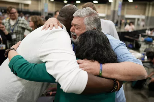 David Meredith, middle, hugs fellow observers after an approval vote at the United Methodist Church General Conference Wednesday, May 1, 2024, in Charlotte, N.C. When the United Methodist Church removed anti-LGBTQ language from its official rules in recent days, it marked the end of a half-century of debates over LGBTQ inclusion in mainline Protestant denominations. The moves sparked joy from progressive delegates, but the UMC faces many of the same challenges as Lutheran, Presbyterian and Episc