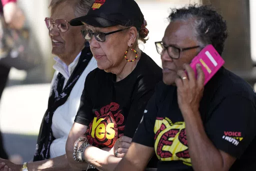 Indigenous women sit on a bench at a polling place in Redfern as Australians cast their final votes in Sydney, Saturday, Oct. 14, 2023, in their first referendum in a generation that aims to tackle Indigenous disadvantage by enshrining in the constitution a new advocacy committee. The prospect of an Indigenous Voice to Parliament has bitterly divided Australia's Indigenous minority as well as the wider community. (AP Photo/Rick Rycroft)