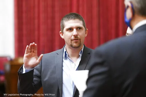 In this image provided by the West Virginia Legislative Photography, Derrick Evans is shown during his swearing-in ceremony to the West Virginia House of Delegates on Dec. 1, 2020, in Charleston, W.Va. Some Jan. 6 defendants who have expressed remorse in court after joining the pro-Trump mob that stormed the Capitol have later struck a different tone or sought to downplay the riot publicly. After pleading guilty to a felony charge in the riot, former West Virginia lawmaker Derrick Evans told a j