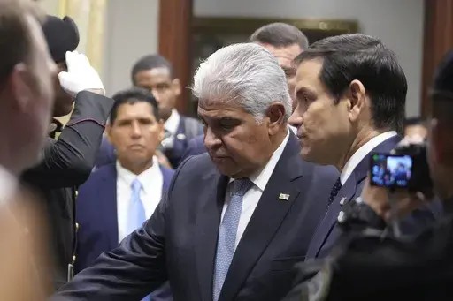 Panama's President Jose Mulino, left, and U.S. Secretary of State Marco Rubio arrive for a meeting at the presidential palace in Panama City, Sunday, Feb. 2, 2025. (AP Photo/Mark Schiefelbein, Pool)