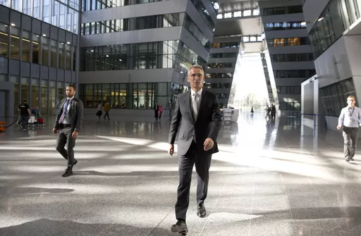 NATO Secretary General Jens Stoltenberg, center, walks in the Agora Hall as he arrives for his first day of work at the new NATO headquarters in Brussels on May 7, 2018. NATO Secretary General Jens Stoltenberg, the top civilian official at the world's biggest security alliance, routinely praises allies for helping Ukraine's troops to fight back. But when he does, Stoltenberg is talking about individual member countries, not NATO as an organization. (AP Photo/Virginia Mayo, File)