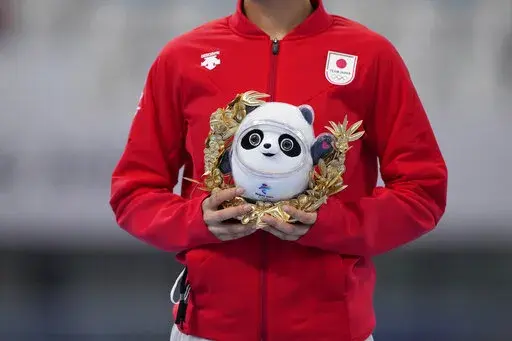 Miho Takagi of Japan waves during a ceremony after winning the silver medal in the women's speedskating 1,500-meter race at the 2022 Winter Olympics, Monday, Feb. 7, 2022, in Beijing. (AP Photo/Sue Ogrocki)