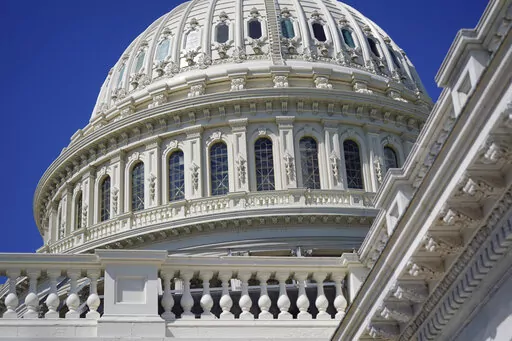 Sun shines on the U.S. Capitol dome in Washington, Aug. 12, 2022. Negotiators have agreed to include more than $12 billion in Ukraine-related aid in a stopgap spending bill that would fund the federal government into mid-December. The package will also provide disaster assistance, including for Jackson, Mississippi, where improvements are needed to the city’s water treatment system. Also in the package is money to help households afford winter heating and to assist Afghans in resettling in the