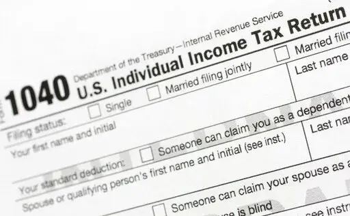 A portion of the 1040 U.S. Individual Income Tax Return form is shown July 24, 2018, in New York. The IRS said Tuesday, June 21, 2022, that it will have erased its backlog of last season's tax returns by the end of this week. (AP Photo/Mark Lennihan, File)