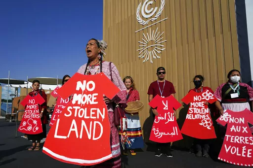 Demonstrators hold signs as part of a protest demanding no more stolen relatives and stolen land with the group Indigenous Women Action at the COP27 U.N. Climate Summit, Tuesday, Nov. 15, 2022, in Sharm el-Sheikh, Egypt. (AP Photo/Peter Dejong)