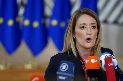 European Parliament President Roberta Metsola speaks with the media as she arrives for an EU summit in Brussels, on Dec. 15, 2022. European Parliament President Roberta Metsola on Monday, Jan. 2, 2023 launched an urgent procedure for the waiver of immunity of two lawmakers following a request from Belgian judicial authorities investigating a major corruption scandal rocking EU politics. (AP Photo/Virginia Mayo, File)