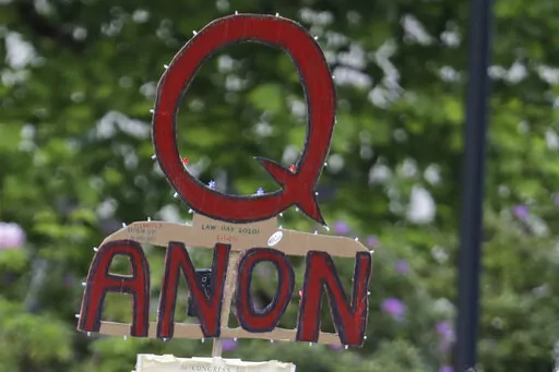 A person carries a sign supporting QAnon during a protest rally in Olympia, Wash., on May 14, 2020. The QAnon conspiracy theory has been linked to acts of real-world violence, including last year's riot at the U.S. Capitol. In June 2021, a federal intelligence report warned that QAnon adherents could target Democrats and other political opponents for more violence. (AP Photo/Ted S. Warren, File)