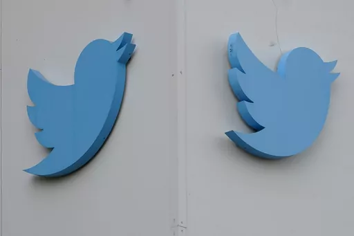 Twitter logos hang outside the company's offices in San Francisco, Monday, Dec. 19, 2022. Ella Irwin, a top Twitter executive responsible for safety and content moderation, has left the company. Her departure came after owner Elon Musk publicly complained about the platform’s handling of posts about transgender topics. (AP Photo/Jeff Chiu, File)