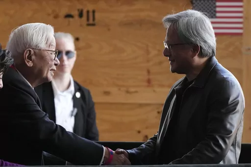 Taiwan Semiconductor Manufacturing Company founder Morris Chang, left, shakes hands with Nvidia Co-founder, President, and CEO Jensen Huang, right, at the TSMC facility under construction in Phoenix, Tuesday, Dec. 6, 2022. Nvidia shares skyrocketed early Thursday after the chipmaker forecast a huge jump in revenue for the next quarter, notably pointing to chip demand for AI-related products and services.(AP Photo/Ross D. Franklin, File)