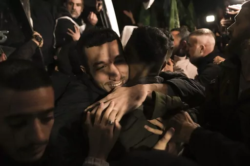 A man smiles as he is welcomed after being released from prison by Israel, Thursday, Nov. 30, 2023, in the West Bank town of Ramallah. The release of Palestinian prisoners under the Israel-Hamas cease-fire agreement last week has touched nearly everyone in the occupied West Bank, where 750,000 Palestinians have been arrested since 1967. In negotiations with Israel to free hostages in Hamas captivity in Gaza, the militant group has pushed for the release of high-profile prisoners. But experts say