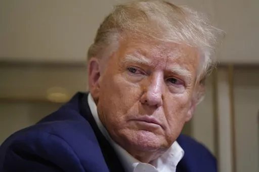Former President Donald Trump listens as he speaks with reporters while in flight on his plane after a campaign rally at Waco Regional Airport, in Waco, Texas, March 25, 2023, while en route to West Palm Beach, Fla. The Supreme Court said Friday, Dec. 22, that it will not immediately take up a plea by special counsel Jack Smith to rule on whether former President Donald Trump can be prosecuted for his actions to overturn the 2020 election results. (AP Photo/Evan Vucci, File)