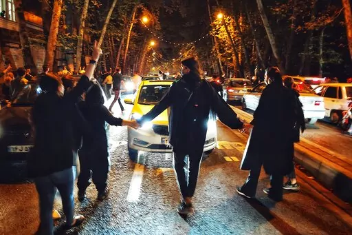 Women protest the death of 22-year-old woman Mahsa Amini who was detained by the morality police, in Tehran, Saturday, Oct. 1, 2022. in this photo taken by an individual not employed by the Associated Press and obtained by the AP outside Iran. Iran said it executed two men Saturday, Jan. 7, 2023, convicted of allegedly killing a paramilitary volunteer during a demonstration, the latest executions aimed at halting the nationwide protests now challenging the country's theocracy. (AP Photo/Middle E