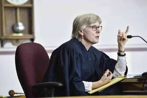FILE Judge Kathy Seeley listens to arguments during a status hearing for Held vs. Montana in the Lewis and Clark County Courthouse in Helena, Mont., on Friday, May 12, 2023. Seeley dismissed part of the lawsuit filed by young people challenging the state's energy policy after the Legislature repealed it. However, she said a trial is still needed to decide if the rules by which the state evaluates fossil fuel development are constitutional because they don't allow consideration of the effect of g