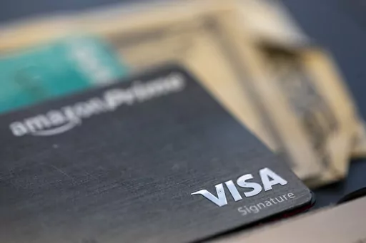 The Visa logo is seen on a credit card in New Orleans, Aug. 11, 2019. When you have credit card debt, the easiest way to deal with it is to diligently make monthly payments of at least the minimum amount due, and more if your budget allows. In doing this, you avoid late fees and your account is considered in good standing. (AP Photo/Jenny Kane, File)