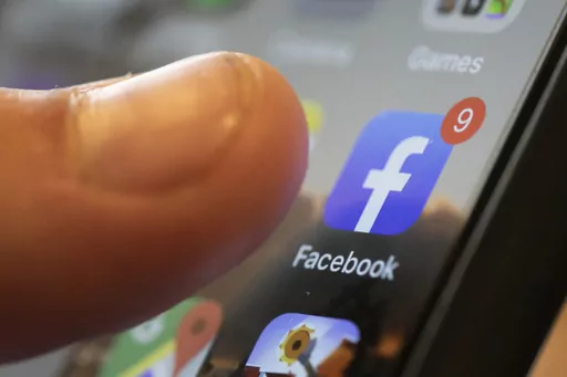 An iPhone displays the Facebook app in New Orleans, Aug. 11, 2019. Facebook says it is not dead. It’s not even just for “old people,” as young people have been saying for years. The social media platform born before the iPhone is approaching two decades in existence. (AP Photo/Jenny Kane, File)
