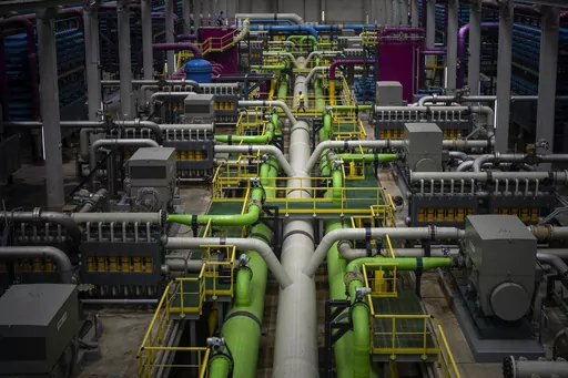 A worker walks over the pipeline that transports seawater to filters at Europe's largest desalination plant for drinking water located in Barcelona, Spain, Tuesday, May 16, 2023. Europe's largest desalination plant for drinking water had largely remained idle since its construction near Barcelona over a decade ago. But since a prolonged drought gripped Spain, the plant has been running at full throttle. (AP Photo/Emilio Morenatti)