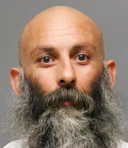 This file booking photo provided by the Delaware Department of Justice shows Barry Croft Jr.  A federal judge has denied a new trial request by two men convicted of conspiring to kidnap Michigan’s Democratic Gov. Gretchen Whitmer. Lawyers for Adam Fox and Croft Jr. alleged misconduct by a juror and unfairness by U.S. District Judge Robert Jonker following their conviction by a federal jury in August. (Delaware Department of Justice via AP, File)