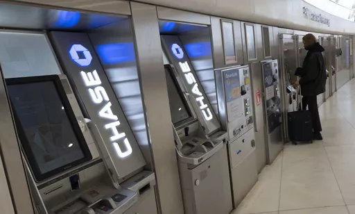 Chase Bank ATMs are shown, Thursday, March 25, 2021, in New York. Customers of Chase’s online banking services were seeing double transactions, fees and/or payments in their accounts, with the situation not immediately being resolved as of late morning on Friday, June 2, 2023. (AP Photo/Mark Lennihan, File)