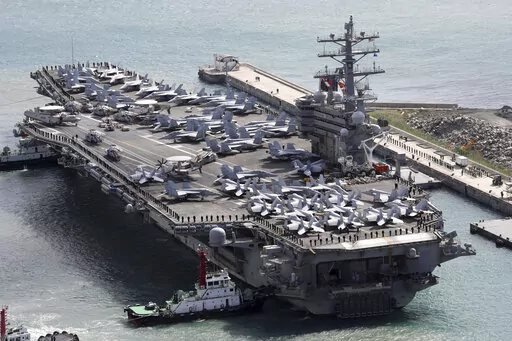 The aircraft carrier USS Ronald Reagan (CVN 76) is escorted into Busan port, South Korea, after completing a joint drill with the South Korean military on Oct. 21, 2017. A U.S. aircraft carrier is to visit South Korea this week for its first joint training with South Korean warships in five years, officials said Monday, Sept. 19, 2022, in an apparent show of force against increasing North Korean nuclear threats. (Jo Jung-ho/Yonhap via AP, File)